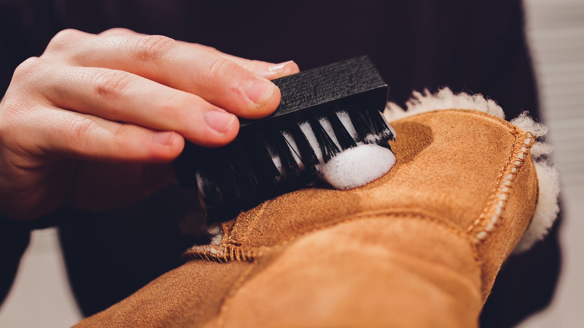man cleaning suede boots
