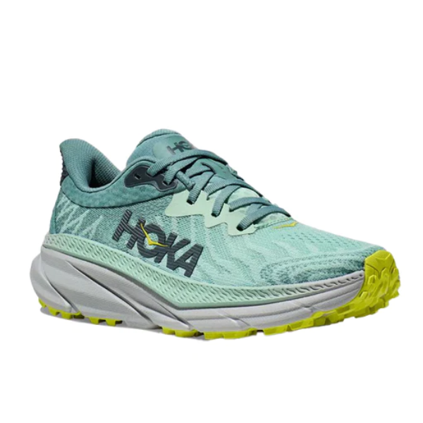 The HOKA Womens Challenger ATR 7 Wide in Mist Green/Trellis features a thick gray sole and yellow-green accents on the tread and branding, shown against a white background.