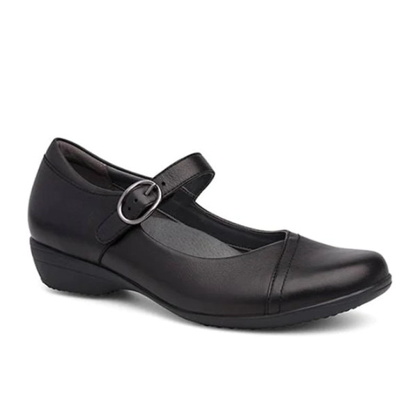 The Dansko Womens Fawna Milled Nappa Black shoe features a low wedge heel, rounded toe, and instep strap with a silver buckle. Designed by Dansko, it offers excellent arch support for comfort and style.