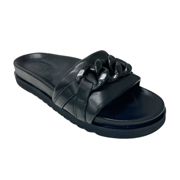 The Sovella Womens Aria Black slide sandal by SOVELLA features a thick black strap with a bold chain-link detail, and a flat sole with subtle arch support and textured grip for minimalist, modern comfort.