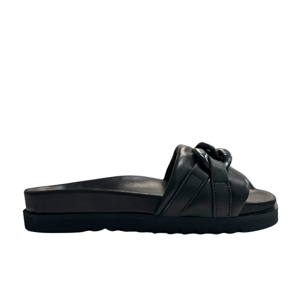 The SOVELLA Womens Aria Black slide sandal features a thick sole, Wide knotted strap, and arch support, shown in side profile on a white background.