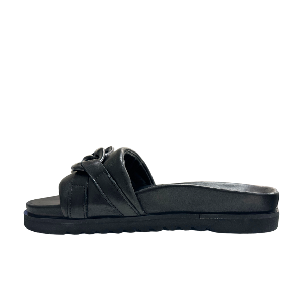The Sovella Womens Aria Black by SOVELLA is a black slide sandal with a thick sole, knotted strap design, and subtle arch support, shown in side profile on a white background.