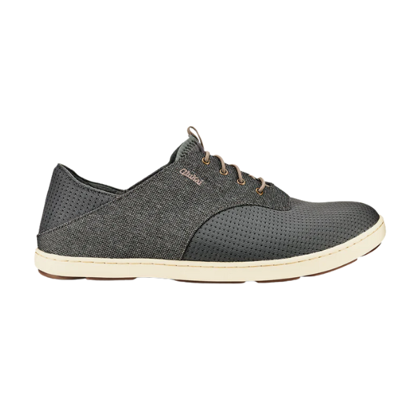 The OLUKAI Men's Nohea Moku Sneaker Grey features a dark gray upper with perforated details, beige sole, brown laces, and subtle side branding, displayed in a side profile view against a white background.