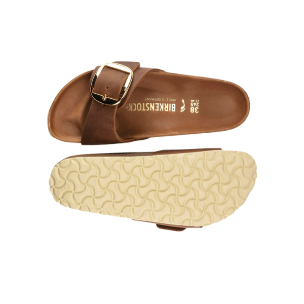 A pair of BIRKENSTOCK Womens Madrid Big Buckle Cognac sandals—one shows the top with a large buckle, while the other displays the textured light sole and signature cork footbed.