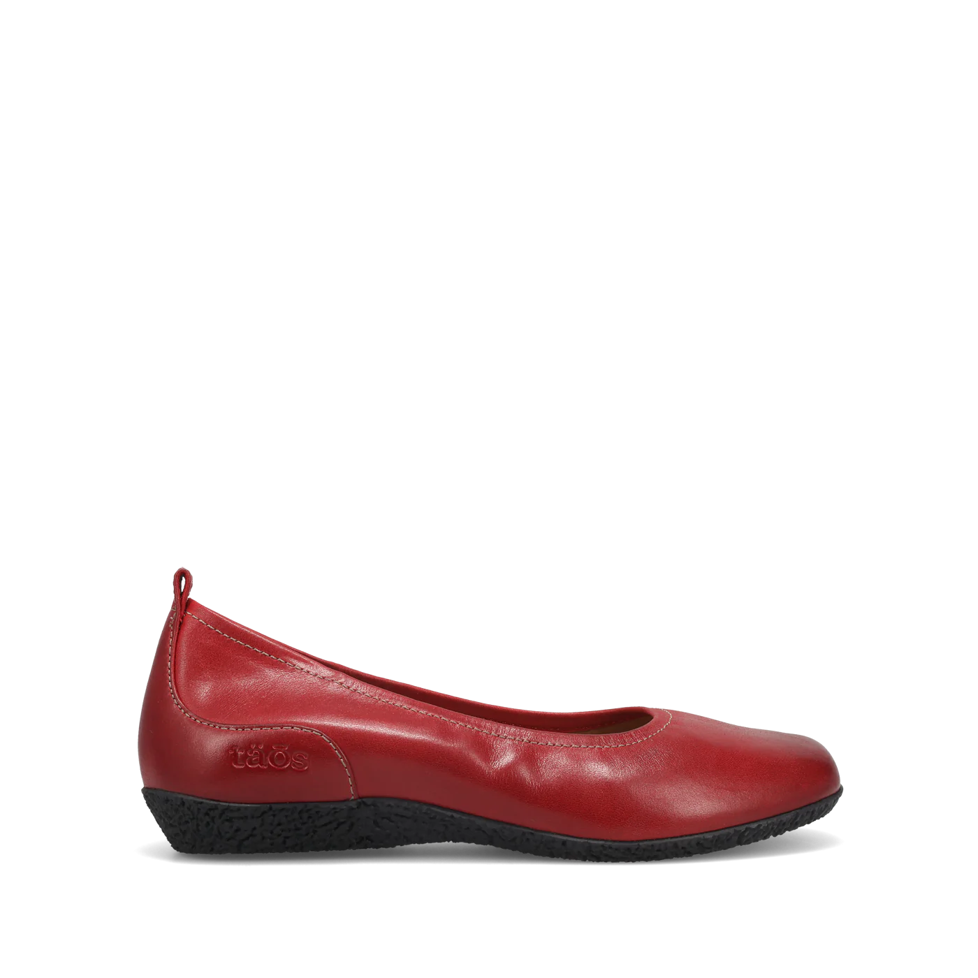 The TAOS Womens Chit Chat Red is a red leather skimmer flat with a rounded toe, black textured sole, slight wedge heel, visible stitching, orthotic-friendly design, and a pull tab at the heel for easy on/off.