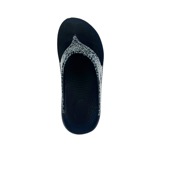 The Sovella Womens PF Thong Black/Leopard by SOVELLA features rebound arch support, a textured sole, and a gray and white leopard print strap, shown on a white background.