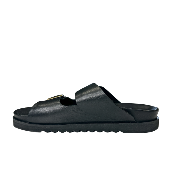 The Sovella Womens Olivia Black by SOVELLA is an open-toe sandal with a Wide strap and buckle, flat sole for arch support, and a slightly textured bottom. Shown in profile on a white background.