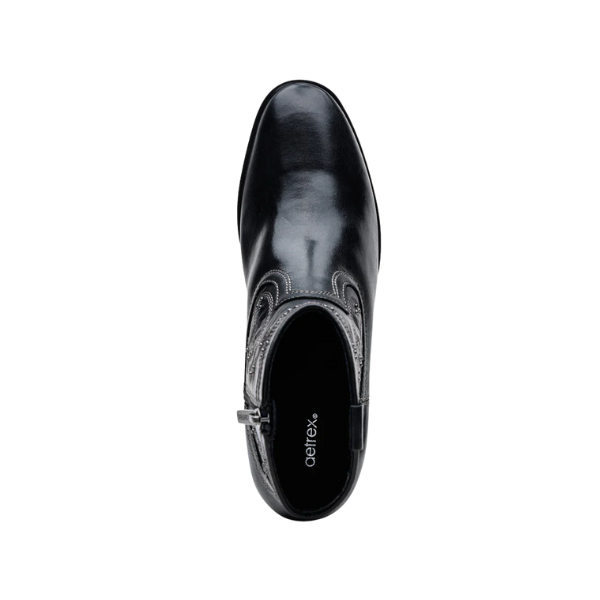 Top view of a single black leather Aetrex Women's Reagan Heel Boot with decorative stitching and side zipper, shown on a white background. The insole displays the AETREX WORLDWide INC brand name and offers comfortable arch support.