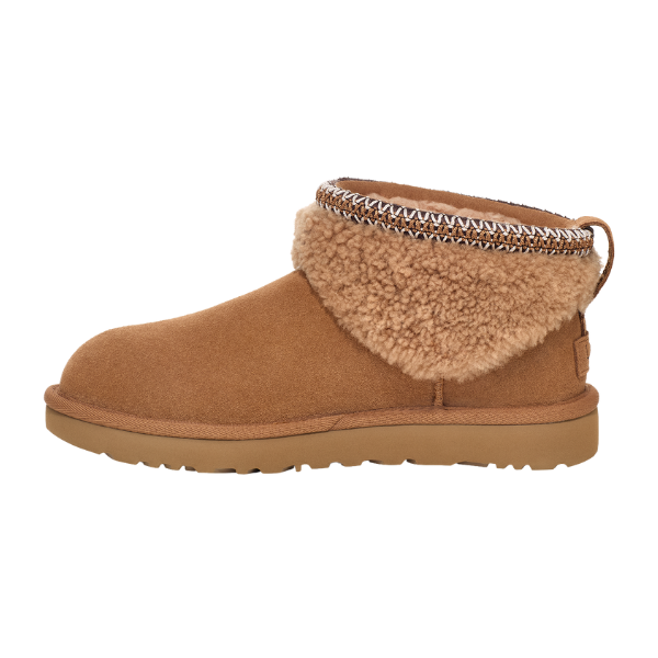Tan suede boot with fur trim on a white background