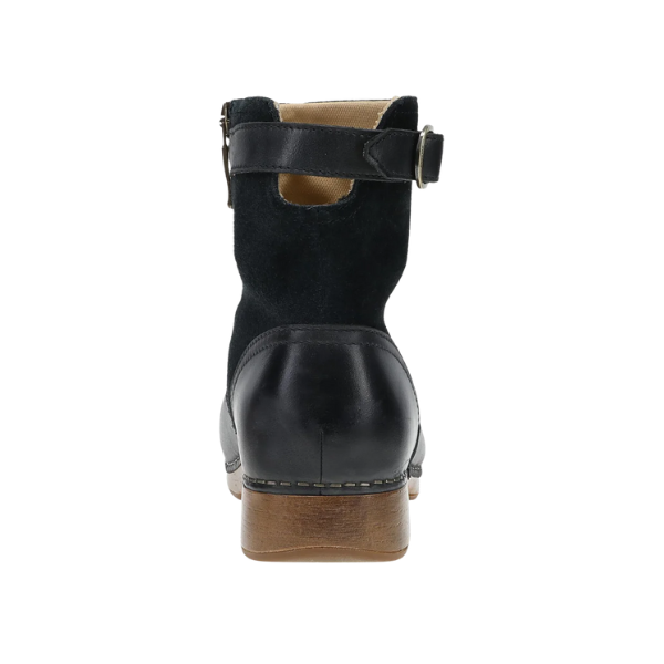Rear view of the DANSKO Women's Monique Black bootie with a wooden heel, ankle strap, and metal buckle.
