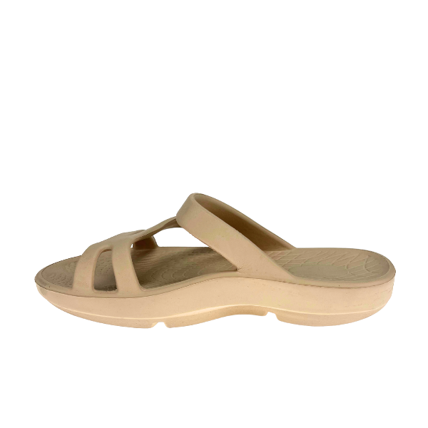 The SOVELLA Sovella Womens PF Slide Beige is a slip-on sandal with two Wide straps, arch support, a comfort recovery design, textured sole, and slight platform heel, shown on a white background.