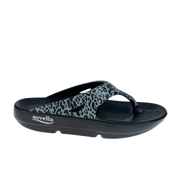 The Sovella Womens PF Thong Black/Leopard is a black flip-flop with a thick sole, grey and black leopard print strap, white SOVELLA branding, and excellent arch support for all-day comfort. Designed as comfort recovery sandals.