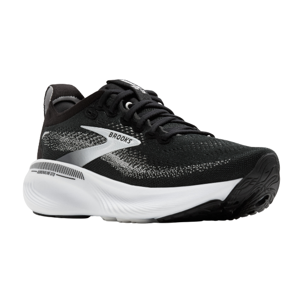 The Brooks Men's Adrenaline GTS 25 Wide Black/White running shoe features a knit upper, white midsole, black outsole, and gradient side details—designed by BROOKS for comfort and foot pain relief on every run.