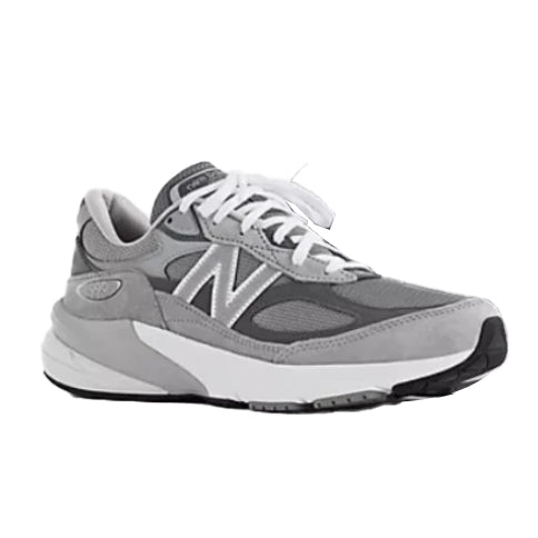 The New Balance Womens 990 v6 Wide Grey sneaker features mesh and suede panels in gray and white, white laces, a chunky sole, and the signature N logo. This MADE in the USA classic blends style and comfort for daily wear.