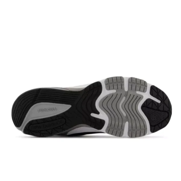 The image shows the sole of the New Balance Mens 990 V6 Black by NEW BALANCE, with black and gray rubber featuring a wavy tread for grip and flexibility. The embossed logo highlights its supportive, foot pain prevention design.