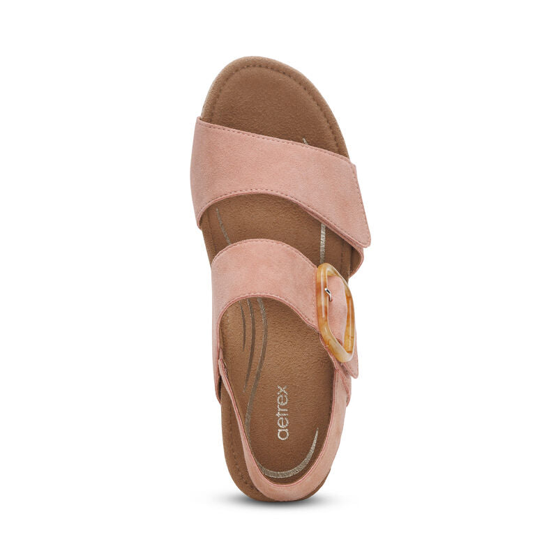 The Aetrex Womens Ashley Espadrille Wedge Rose by AETREX WORLDWide INC features a Wide pink strap, overlapping strap with tan round buckle, cushioned brown insole, and arch support—perfect wedges for plantar fasciitis relief.