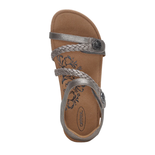 The Aetrex Womens Jillian Brushed-Silver sandal by AETREX features braided metallic silver adjustable straps with button accents, a tan orthotic floral footbed, a supportive back strap, and an open toe design.