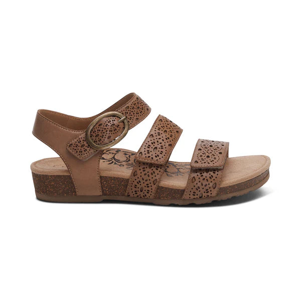 The Aetrex Womens Lilly Cutout Taupe by AETREX WORLDWide INC features an open-toe design with three cutout straps, buckle closure, and a low cork sole. Its memory foam footbed and arch support ensure all-day comfort.