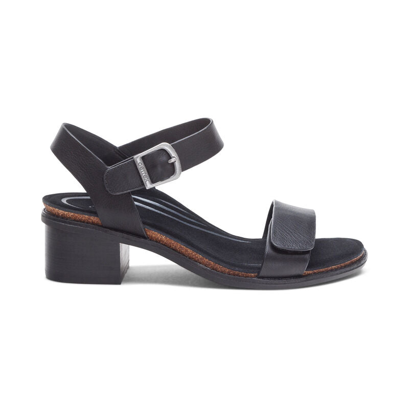 The Aetrex Womens Mae Black by AETREX WORLDWide INC is an open-toe sandal featuring a comfort-focused anatomical insole, low block heel, Wide toe strap, and adjustable ankle quarter strap with silver buckle.