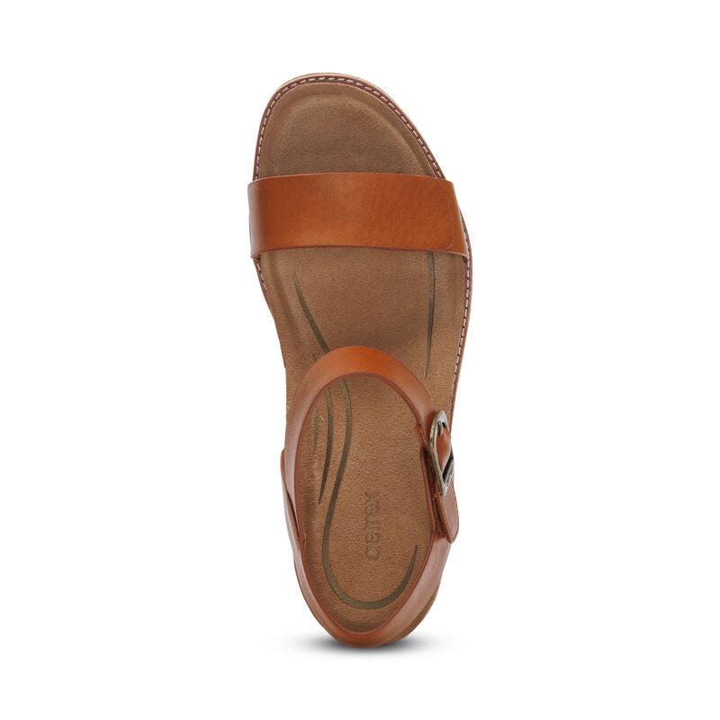 Top view of the Aetrex Womens Mae Cognac sandal by AETREX WORLDWide INC, featuring a leather upper with Wide toe strap, ankle buckle, cushioned footbed, visible edge stitching, and a stylish block heel.