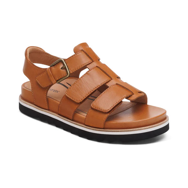 The Aetrex Womens Romy Ginger by AETREX WORLDWide INC is a brown leather sandal with adjustable multi-straps, side buckle closure, and a cushioned sole with white stripe and black textured bottom—ideal for everyday comfort.