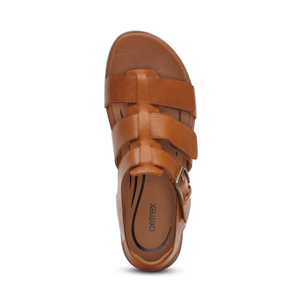 Top view of the Aetrex Women's Romy Ginger sandal by AETREX WORLDWide INC—brown leather comfort style with three horizontal straps, a side buckle, and logo on the insole, ideal for plantar fasciitis support.