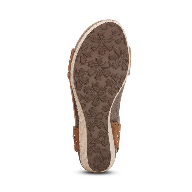 The image shows the bottom view of the Aetrex Womens Sydney Scotch Cutout sandal by AETREX WORLDWide INC, featuring brown straps, an espadrille-style edge, floral-patterned sole for traction, and arch support for all-day comfort.