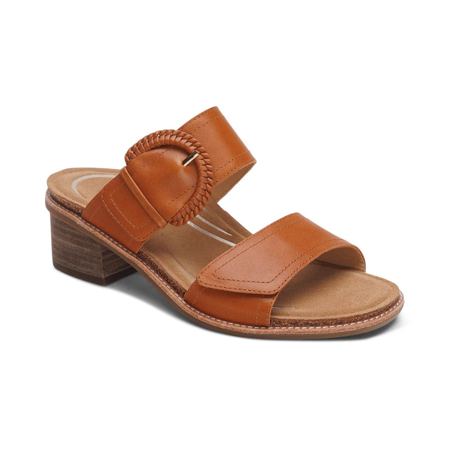 The Aetrex Womens Tatiana Cognac by AETREX WORLDWide INC features two Wide brown leather straps, a round buckle, cushioned insole, and low stacked heel—perfect for foot pain relief and stylish comfort. Shown on a white background.