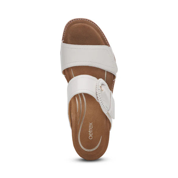 The Aetrex Womens Tatiana Ivory sandal by AETREX WORLDWide INC features two Wide straps with adjustable hook & loop closures, a buckle, and a tan cushioned footbed designed for foot pain relief.