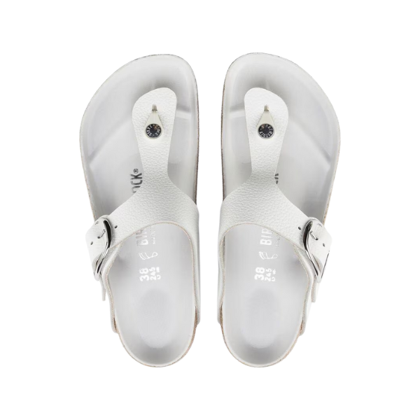 A pair of BIRKENSTOCK Womens Gizeh Big Buckle Leather White sandals with large buckled straps and textured soles, shown from above on a white background.