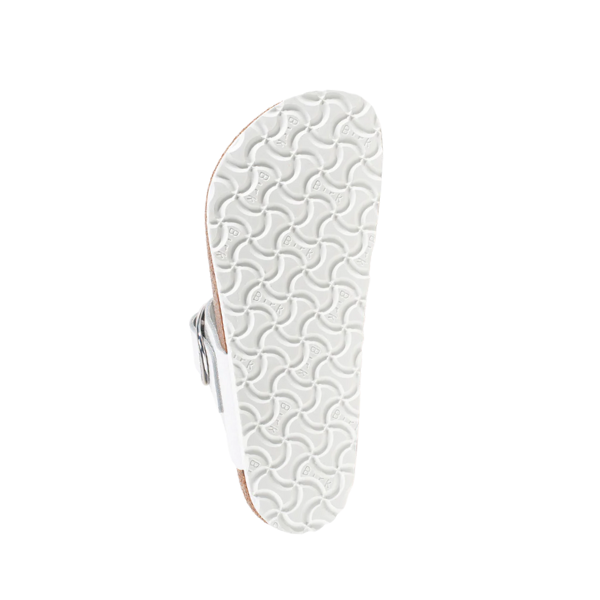 The image displays the underside of a BIRKENSTOCK Womens Gizeh Big Buckle Leather White sandal with a wavy-textured sole and a large buckle on the upper strap, set against a plain white background.