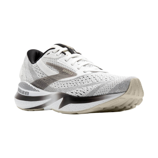 The Brooks Womens Adrenaline GTS 24 by BROOKS is a white and gray running shoe with black accents, a breathable mesh upper, and a textured beige sole with GuideRails Support for improved grip and stability.