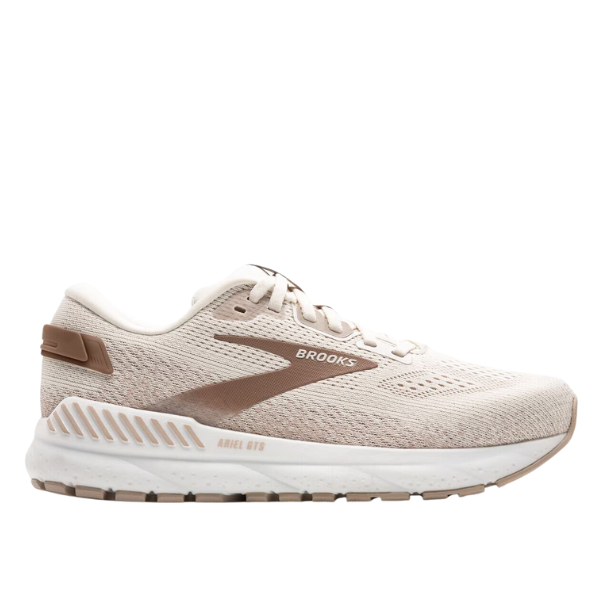 The Brooks Womens Ariel GTS 24 Wide Coconut is a beige and light brown running shoe with a white sole, mesh upper, BROOKS branding, and lace-up closure. It offers maximum support with a cushioned heel and GuideRails support system.
