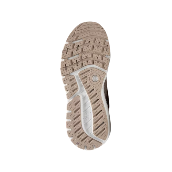 The image shows the beige outsole of the BROOKS Womens Ariel GTS 24 Wide Coconut sneaker, with patterned grooves, rectangular lugs, and a circular detail near the heel for support and stability, set against a white background.