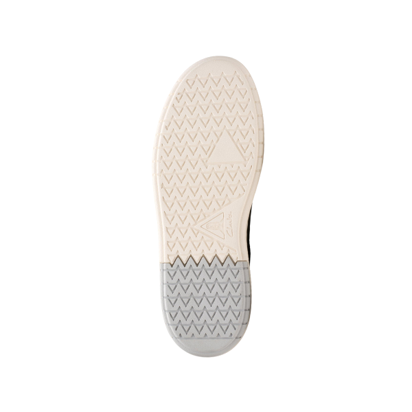 The image shows the bottom sole of the Clarks Mens Courtlite 2 Run Navy sneaker by CLARKS, featuring an off-white textured herringbone pattern with an embossed triangle logo in the center and a light gray heel area for extra grip.