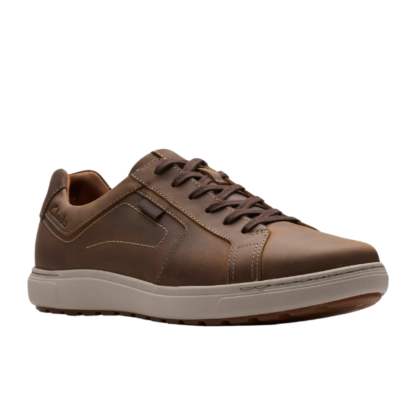 The CLARKS Mens Mapstone Lace Wide Beeswax sneaker features rich beeswax leather, dark brown laces, light tan stitching, a beige rubber sole, and supportive cushioning—all shown on a white background.