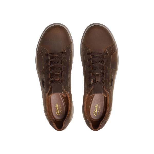 A pair of Clarks Mens Mapstone Lace Wide Beeswax sneakers by CLARKS is shown from above on a white background, featuring dark brown laces, visible stitching, cushioned support, and the gold CLARKS logo on the insoles.