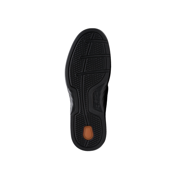 The image displays the black rubber sole of the CLARKS Un Briley Pace Wide mens comfort shoe, which has textured tread patterns for grip and a small brown oval near the heel. The shoe is shown against a white background.