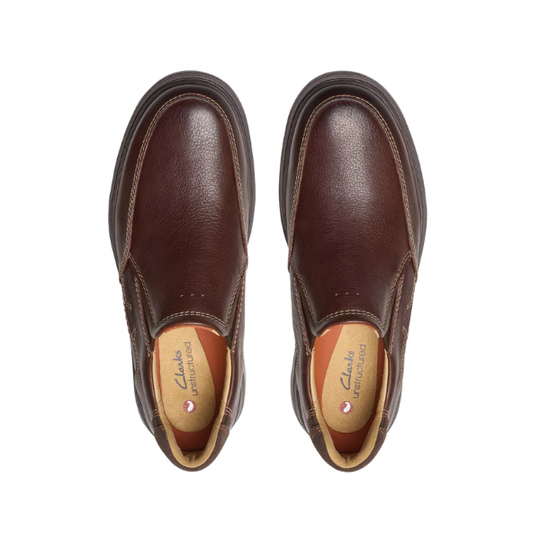 A pair of Clarks Mens Un Briley Step Leather Wide Mahogany slip-on shoes with tan interiors, shown from above on a white background. The contoured insoles display the CLARKS brand name, emphasizing comfort.