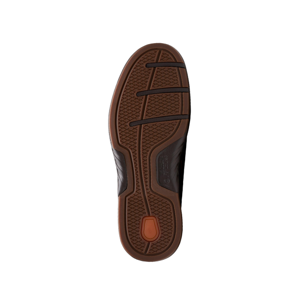 The image shows the sole of the CLARKS Mens Un Briley Step Wide Beeswax shoe, with black and orange rubber details, textured grip patterns, crisscrossing lines, and a small orange oval near the heel.