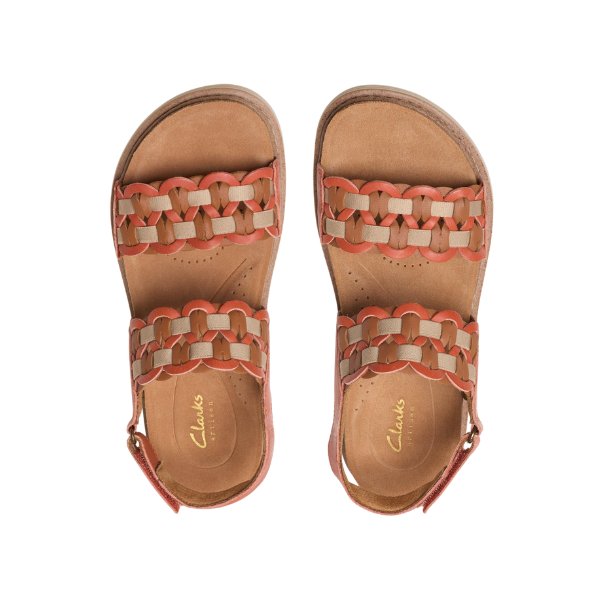 A pair of orange Clarks Womens Arwell Glide Wide sandals with ankle straps, viewed from above on a white background. The insoles feature the gold CLARKS logo and a Contour Cushion Footbed for comfort.