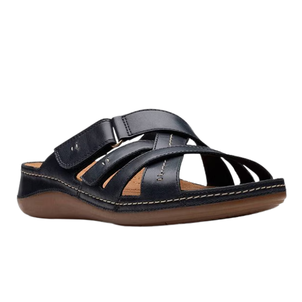 The CLARKS Cecily Slide Leather Wide Black sandal features black straps, a low brown sole with visible stitching, an open toe, adjustable top strap, and a Contour Cushioned footbed for all-day comfort.