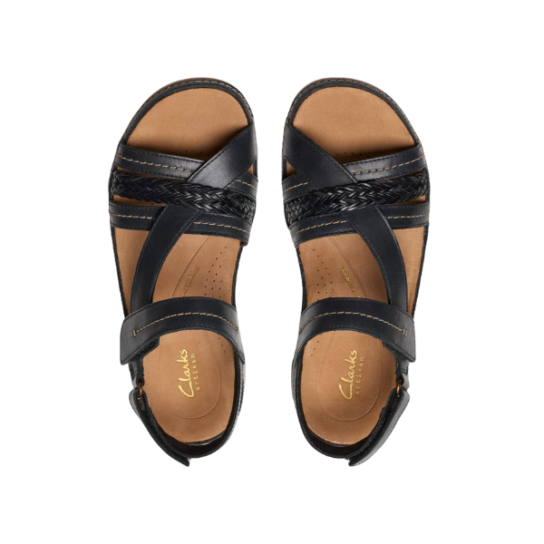 A pair of CLARKS Womens Cecily Strap Leather Wide Black Combo sandals with crisscross straps and tan cushioned insoles, shown from above on a white background.
