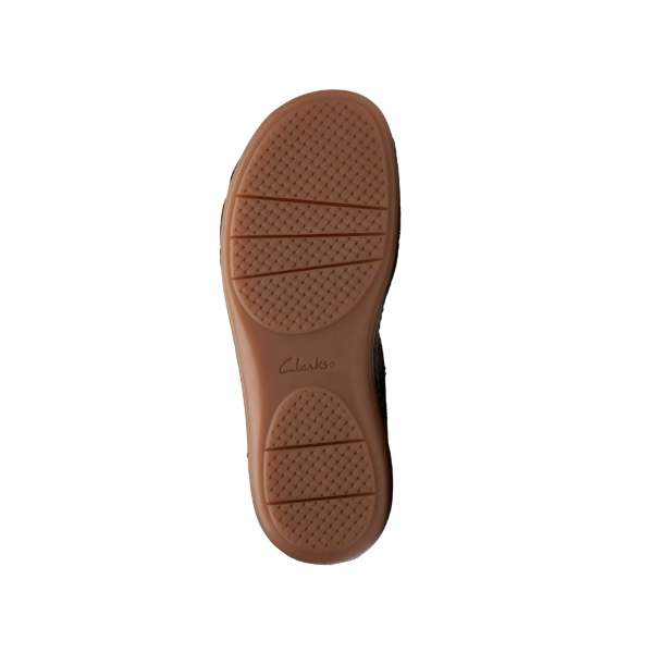 The image displays the brown rubber sole of a CLARKS Womens Cecily Strap Leather Wide Black Combo sandal, with textured grip patterns and the CLARKS logo embossed at the center against a plain white background.