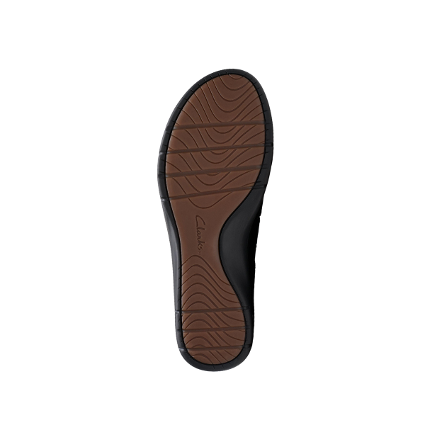 The sole of the Clarks Womens Certina Ease Wide Black shoe by CLARKS is shown from the bottom view, displaying brown and black colors, textured grip patterns for comfort, and a central Clarks logo against a white background.