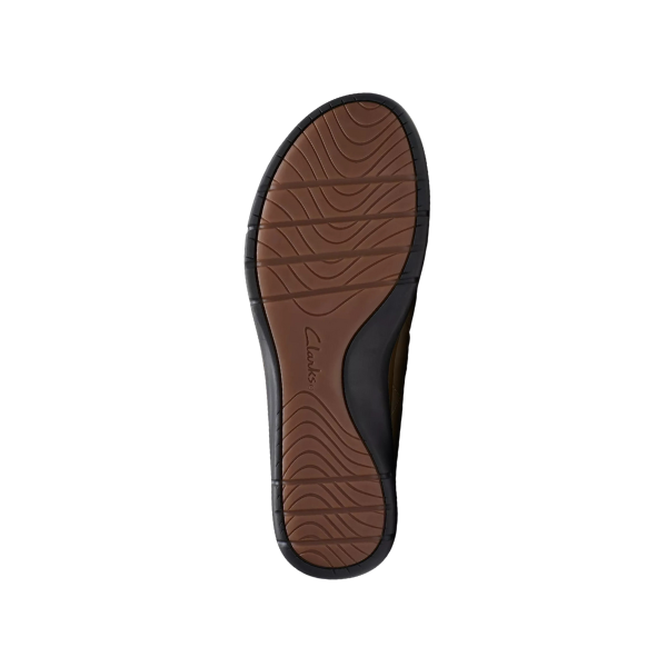 The image displays the sole of the Clarks Womens Certina Ease Wide Pebble shoe, with a brown and black textured pattern and wavy grip lines. The CLARKS logo appears in the center, set against a plain white background.