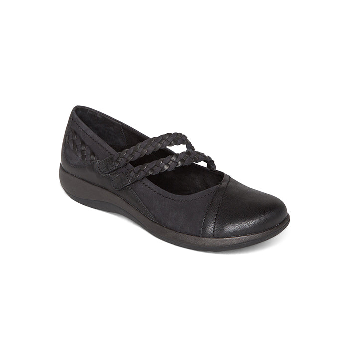The Aetrex Womens Annie Mary Jane Black by AETREX WORLDWide INC is a black flat with a round toe, low wedge heel, two braided straps, and an orthotic footbed for extra support—ideal for those with plantar fasciitis.