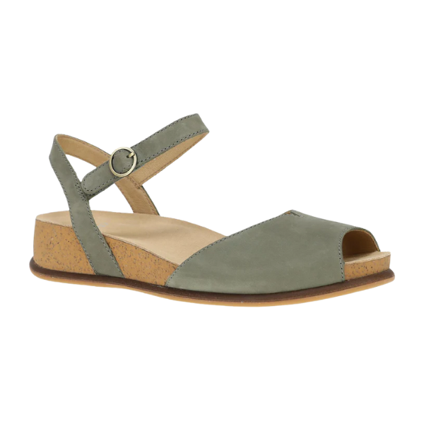 The Dansko Womens Cass Sage Nubuck by DANSKO is a sage green peep toe sandal with an ankle strap, buckle, cork wedge sole, and low heel. Its minimalist design features a closed back and exposed sides for foot pain relief.