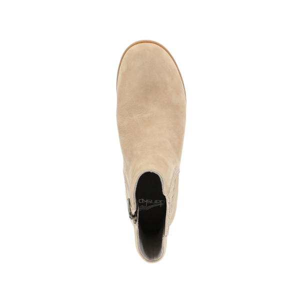 Top view of the DANSKO Womens Daisie Waterproof Sand slip-on, showcasing a rounded toe, black interior, tan outsole with Natural Arch technology, displayed on a white background.