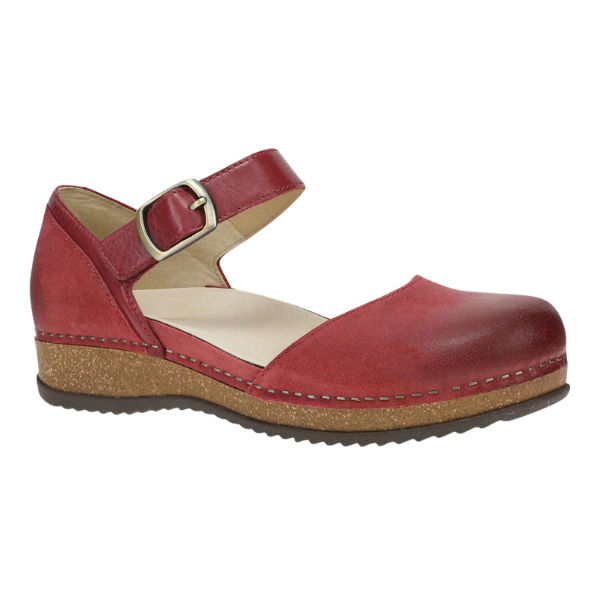 The Dansko Womens Mae Red Suede by DANSKO features a single red suede Mary Jane design with an ankle strap and buckle, round toe, cushioned beige insole, and lightweight textured brown EVA and cork sole with light edge stitching.